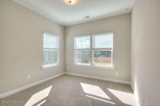 empty room featuring light colored carpet