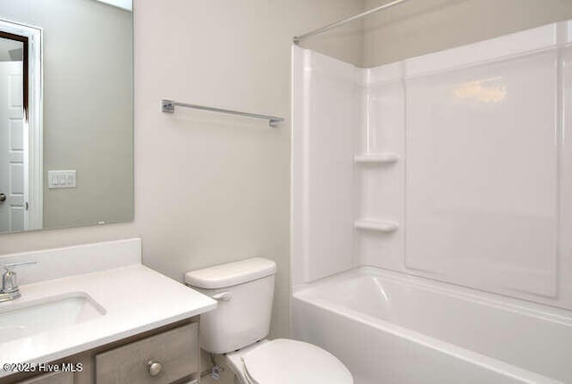 full bathroom featuring vanity, bathtub / shower combination, and toilet