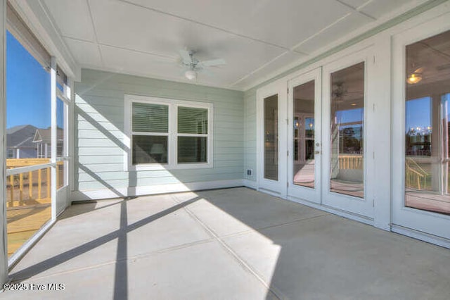 unfurnished sunroom with a paneled ceiling and ceiling fan