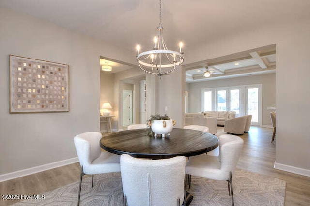 dining area featuring coffered ceiling, a chandelier, beam ceiling, and light hardwood / wood-style floors