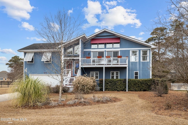 view of front of property featuring stairs, fence, and a garage