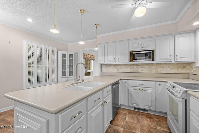 kitchen with pendant lighting, sink, backsplash, stainless steel appliances, and a textured ceiling