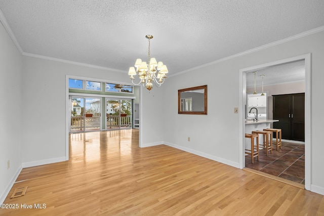 interior space with ornamental molding, light wood-type flooring, and a notable chandelier