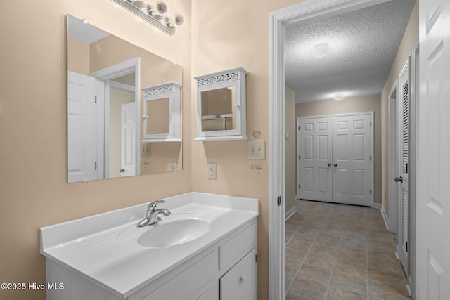 bathroom featuring vanity and a textured ceiling