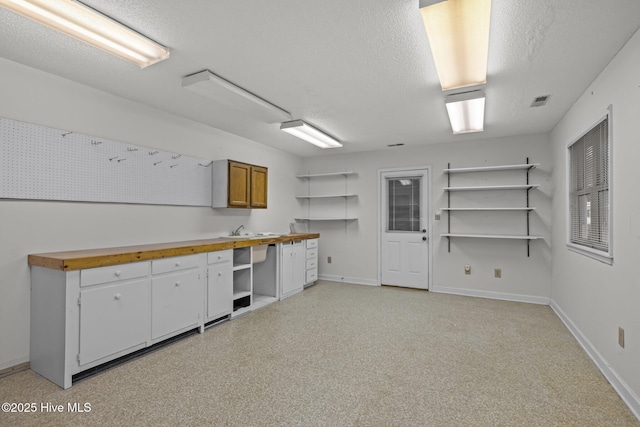 basement with sink and a textured ceiling