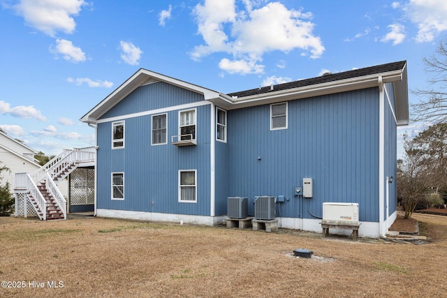 back of property featuring a yard, cooling unit, and central AC unit