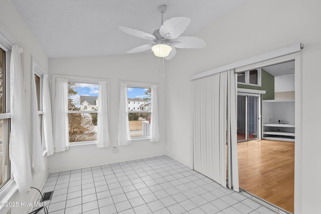 unfurnished sunroom featuring vaulted ceiling and ceiling fan