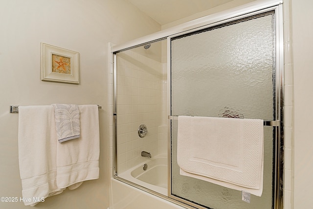 bathroom featuring bath / shower combo with glass door