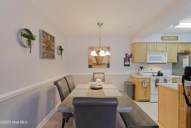 dining area with light tile patterned floors and a notable chandelier