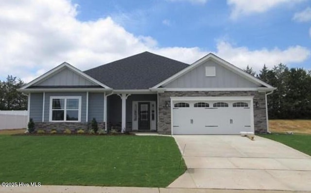 craftsman-style house featuring a garage and a front lawn