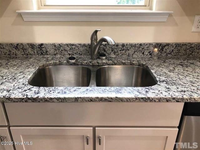 room details with stone countertops and sink