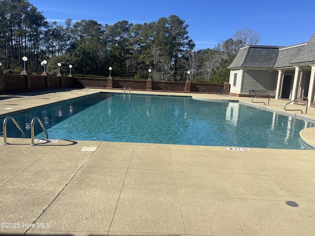 view of swimming pool featuring a patio area