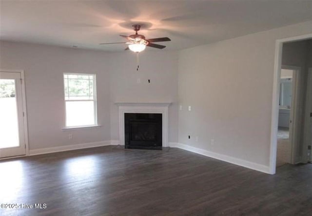 unfurnished living room with dark wood-type flooring and ceiling fan