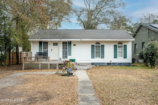 view of front facade with cooling unit and a front lawn