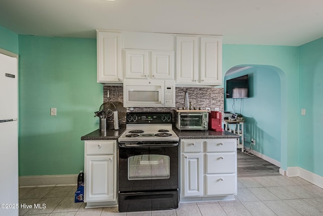 kitchen featuring tasteful backsplash, light tile patterned floors, white appliances, and white cabinets