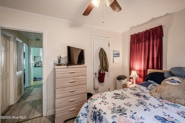 bedroom with ornamental molding and ceiling fan