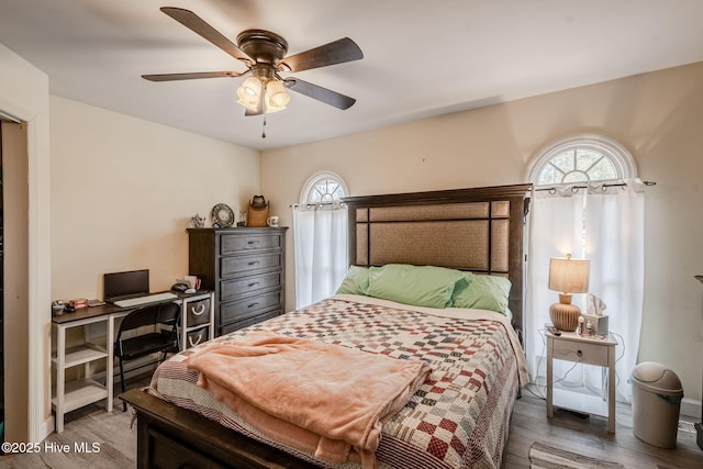 bedroom with ceiling fan and wood-type flooring