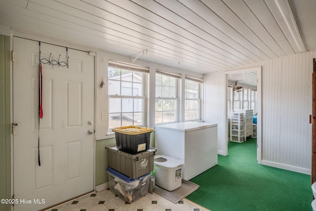 interior space with plenty of natural light, carpet floors, and wooden ceiling