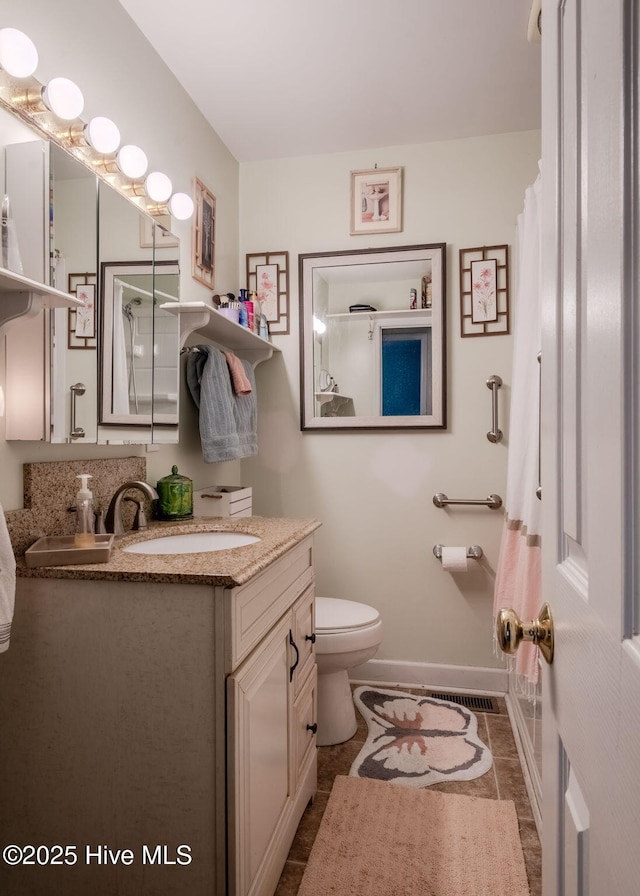 bathroom with vanity, tile patterned floors, and toilet