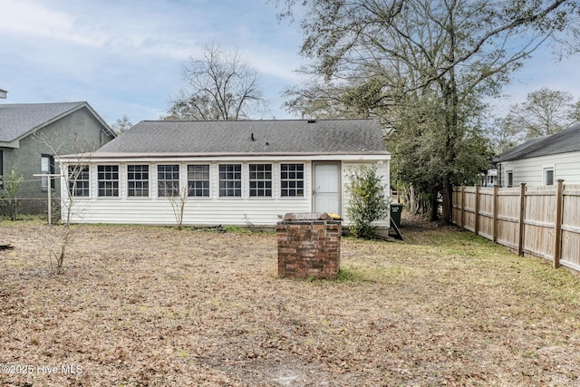 rear view of house featuring a lawn