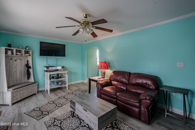 living room featuring hardwood / wood-style flooring, ornamental molding, and ceiling fan