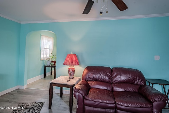 living room featuring ornamental molding, ceiling fan, and light hardwood / wood-style floors