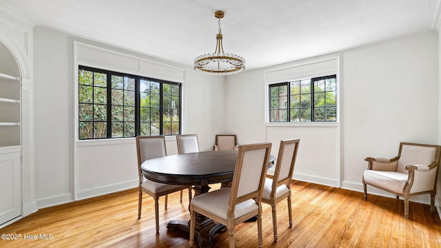 dining space featuring an inviting chandelier and light hardwood / wood-style floors