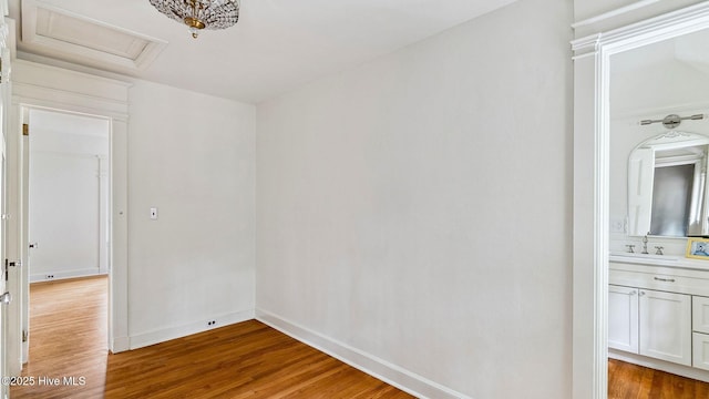 spare room with sink and hardwood / wood-style floors