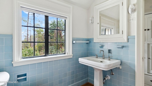 bathroom with tile walls