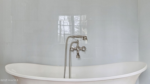 bathroom featuring sink and a washtub