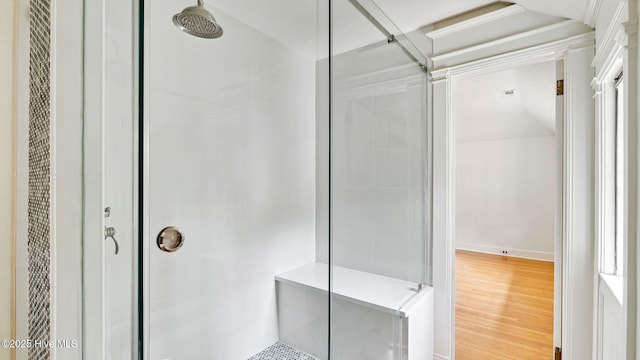 bathroom featuring crown molding, wood-type flooring, and walk in shower