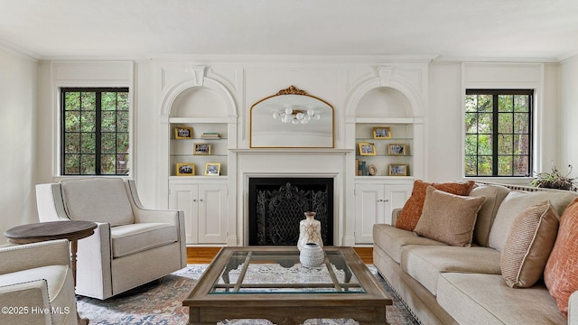 living room featuring ornamental molding, dark hardwood / wood-style flooring, and built in features