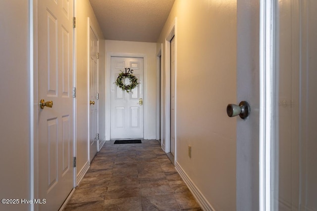 corridor with a textured ceiling