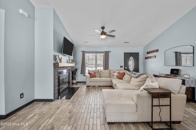 living room with lofted ceiling, light hardwood / wood-style flooring, and ceiling fan