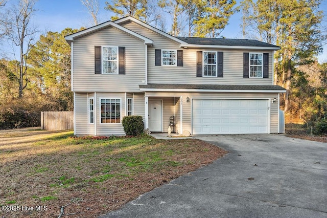 view of front of property with a garage and a front lawn