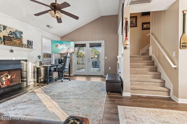 office with vaulted ceiling, dark hardwood / wood-style floors, ceiling fan, and french doors