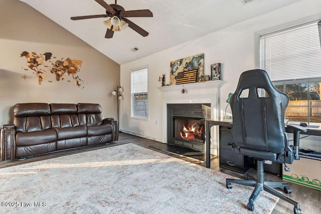 office area featuring ceiling fan, lofted ceiling, a healthy amount of sunlight, and dark hardwood / wood-style flooring