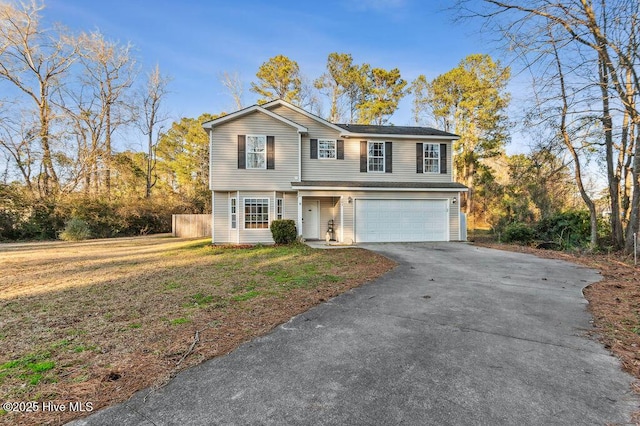 front of property with a garage and a front lawn