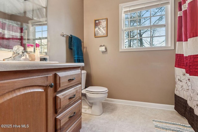 bathroom with vanity, toilet, curtained shower, and tile patterned flooring