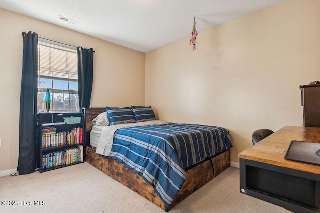 carpeted bedroom featuring a textured ceiling