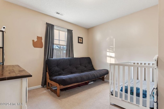 carpeted bedroom featuring a textured ceiling