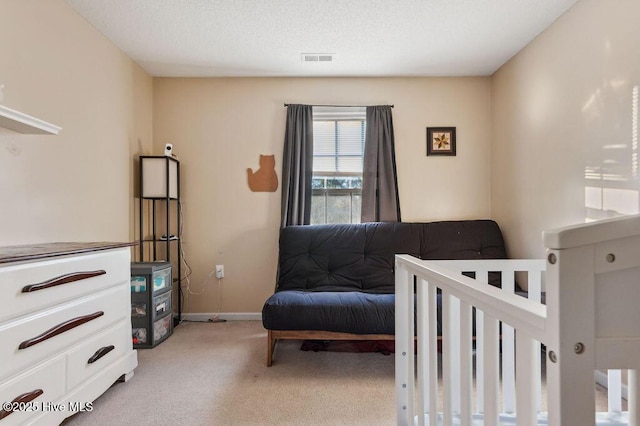 carpeted bedroom featuring a textured ceiling