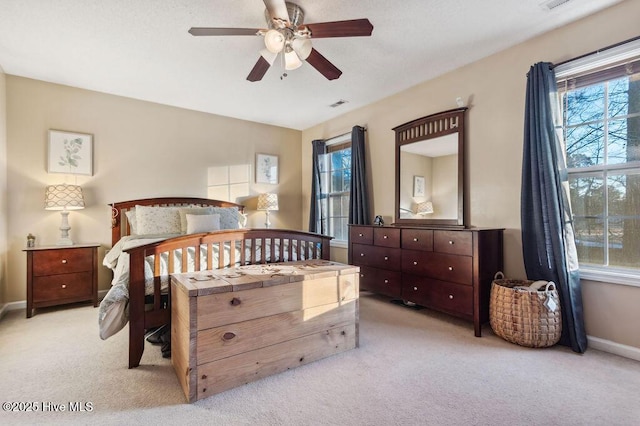 bedroom featuring ceiling fan and light carpet