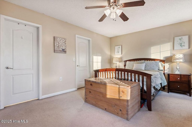 carpeted bedroom featuring a textured ceiling and ceiling fan