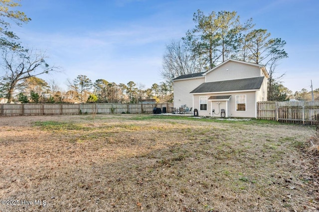 back of house with a yard