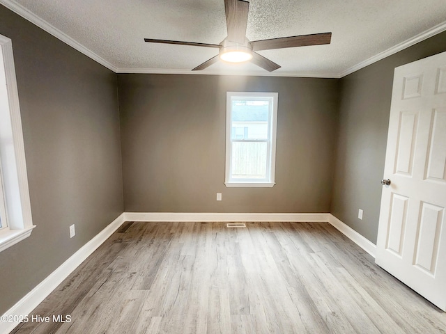 empty room with crown molding, ceiling fan, light hardwood / wood-style floors, and a textured ceiling