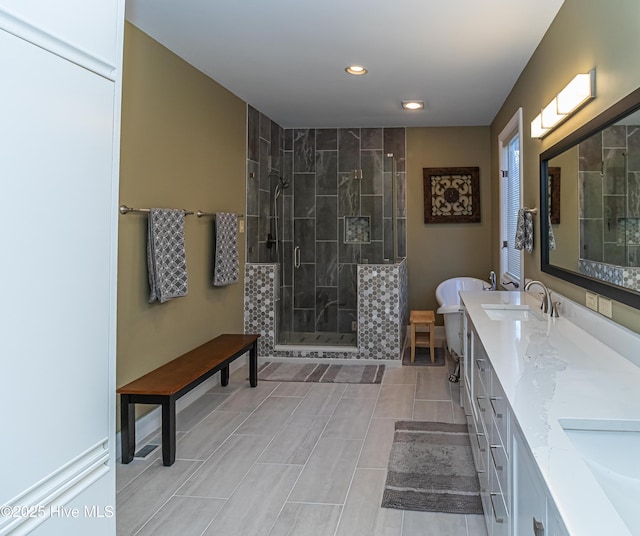 bathroom with walk in shower and vanity