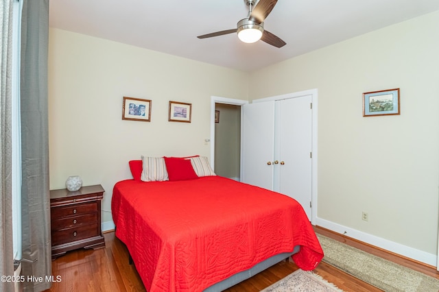 bedroom featuring hardwood / wood-style floors, a closet, and ceiling fan