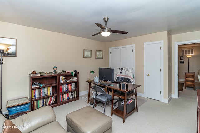 office space featuring ceiling fan and light carpet