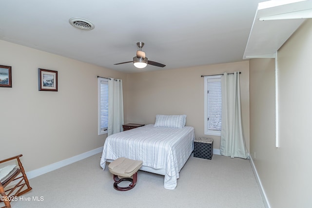 bedroom with ceiling fan and light carpet